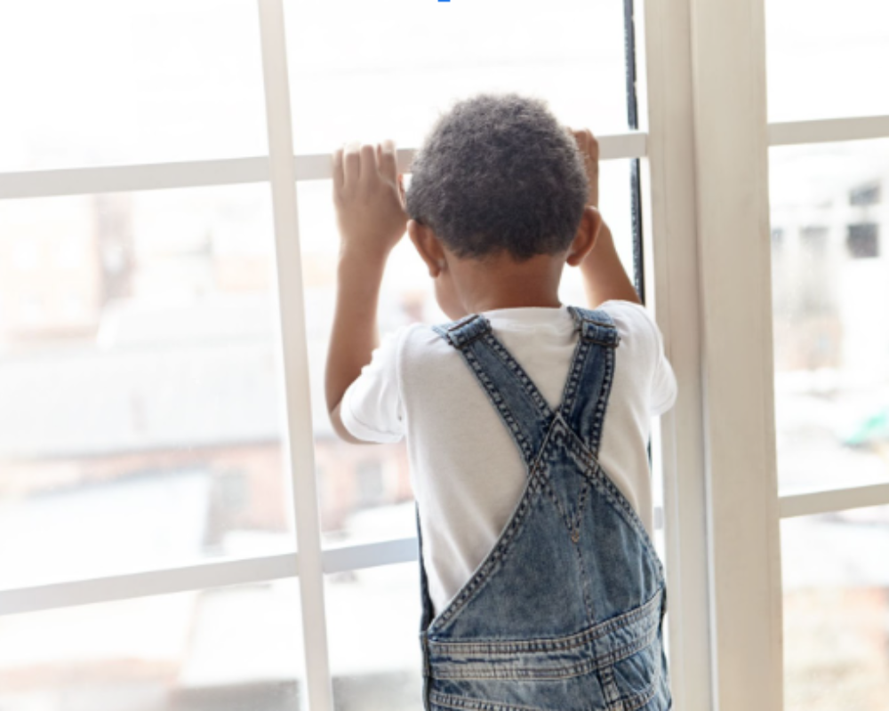 Little boy looking out of Earthwise vinyl windows